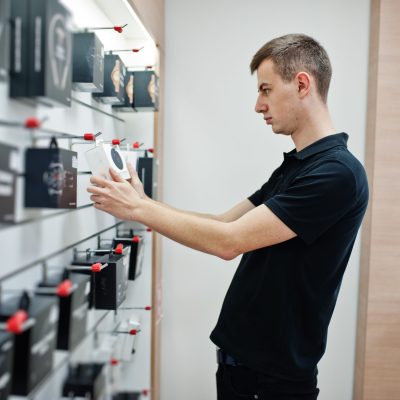 Seller man mobile phone professional consultant in tech store or shop.